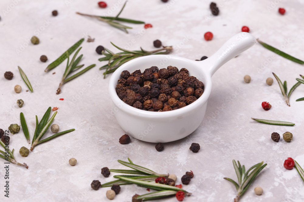 Black pepper inside a white dish.