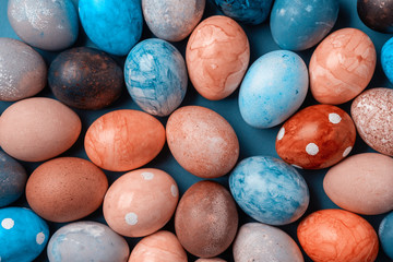 Different easter eggs on blue table