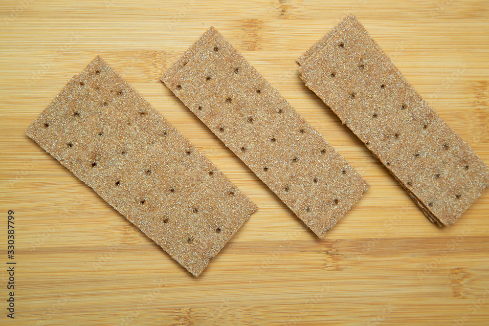 Crunchy bread on a wooden background. Good nutrition.