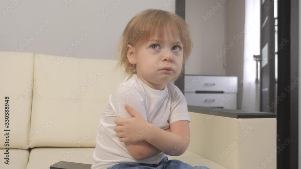 little a girl offended hugs lifestyle herself with her hands. blonde girl indoors angry little a girl offended hugs lifestyle herself with her hands. blonde girl indoors angry