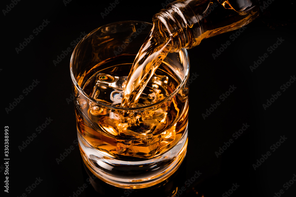 glass of whiskey on black background glass of whiskey on black background
