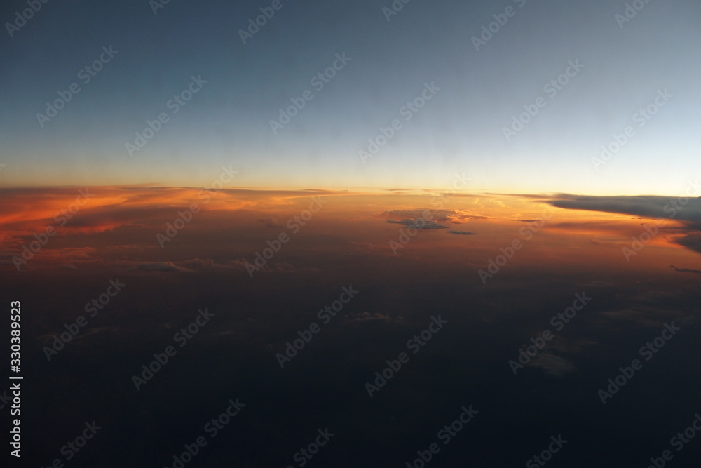  mysterious sunset with clouds from the airplane window with