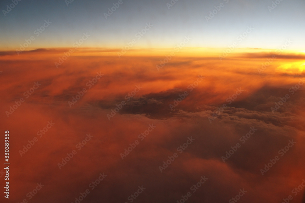  mysterious sunset with clouds from the airplane window with