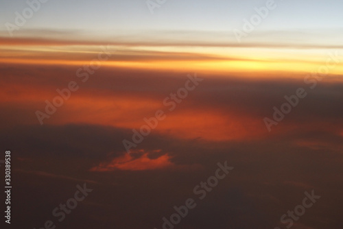  mysterious sunset with clouds from the airplane window with © Joanna Redesiuk