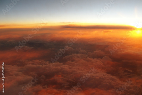  mysterious sunset with clouds from the airplane window with