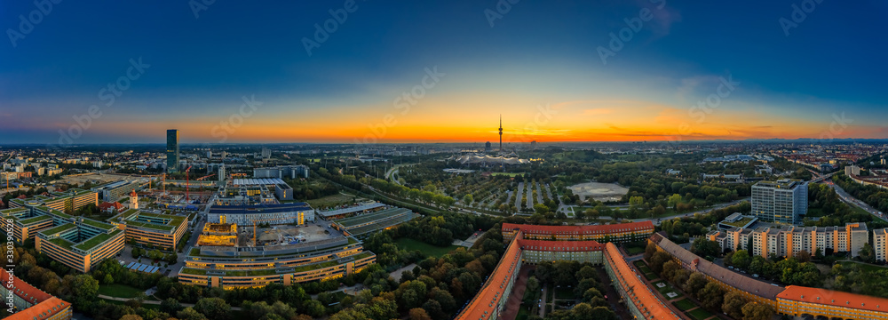 Fototapeta View over Munich as a sunrise panorama with office buildings in the foreground