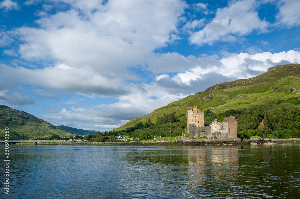 Eilean Donan Castle and scottish highlands landscape view from the water. Hebrides, Scotland. Eilean Donan Castle and scottish highlands landscape view from the water. Hebrides, Scotland.