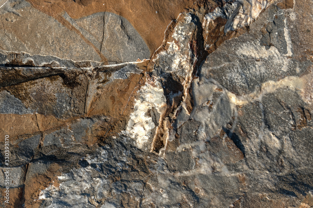 natural surface of brown stone with black and white spots, rock texture