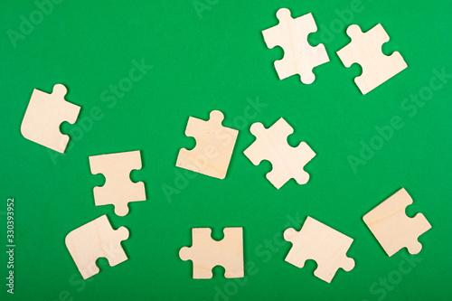 collect puzzles. puzzle pieces scattered on a green background