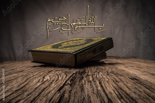 Bismillah - Mean In The Name Of Allah Arabic art with Koran - holy book of Muslims ( public item of all muslims ) .