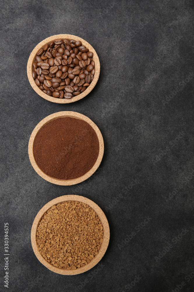 Coffee various - roasted beans or grain and ground and instant coffee on black fabric background. The sequence of preparation of the drink. Coffee concept. Flat lay. Top view. Copy space for text. Coffee various - roasted beans or grain and ground and instant coffee on black fabric background. The sequence of preparation of the drink. Coffee concept. Flat lay. Top view. Copy space for text.