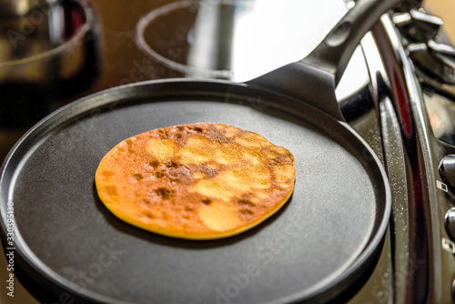 Wallpaper Mural pancake frying pan with crepe pancake cooking on cooker in kitchen Torontodigital.ca