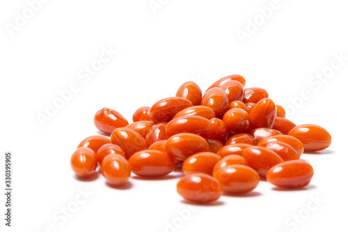 A bunch of orange tablets on a white background. Side view