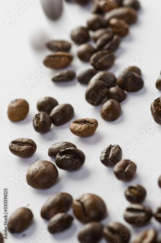 Roasted coffee grains on white background