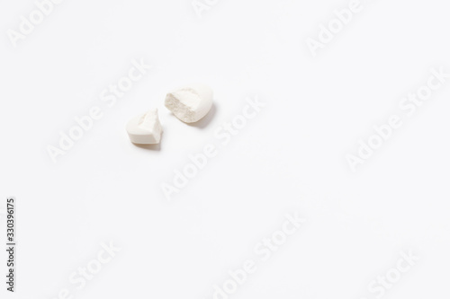 The tablet is white broken into two halves on a white background. Isolated