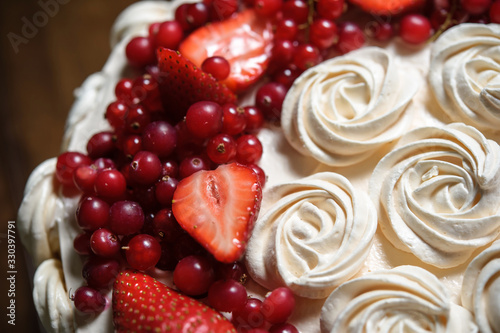 Close-up of pastry chef or baker in apron presenting  freshly baked cake. image for bakeries, confectioneries, food blogs, celebrating special occasions like birthday, wedding,  anniversaries