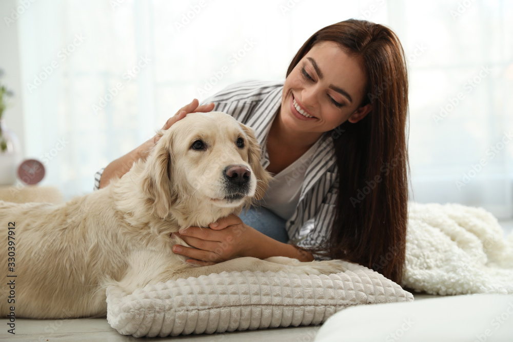 Young woman and her Golden Retriever at home. Adorable pet Young woman and her Golden Retriever at home. Adorable pet
