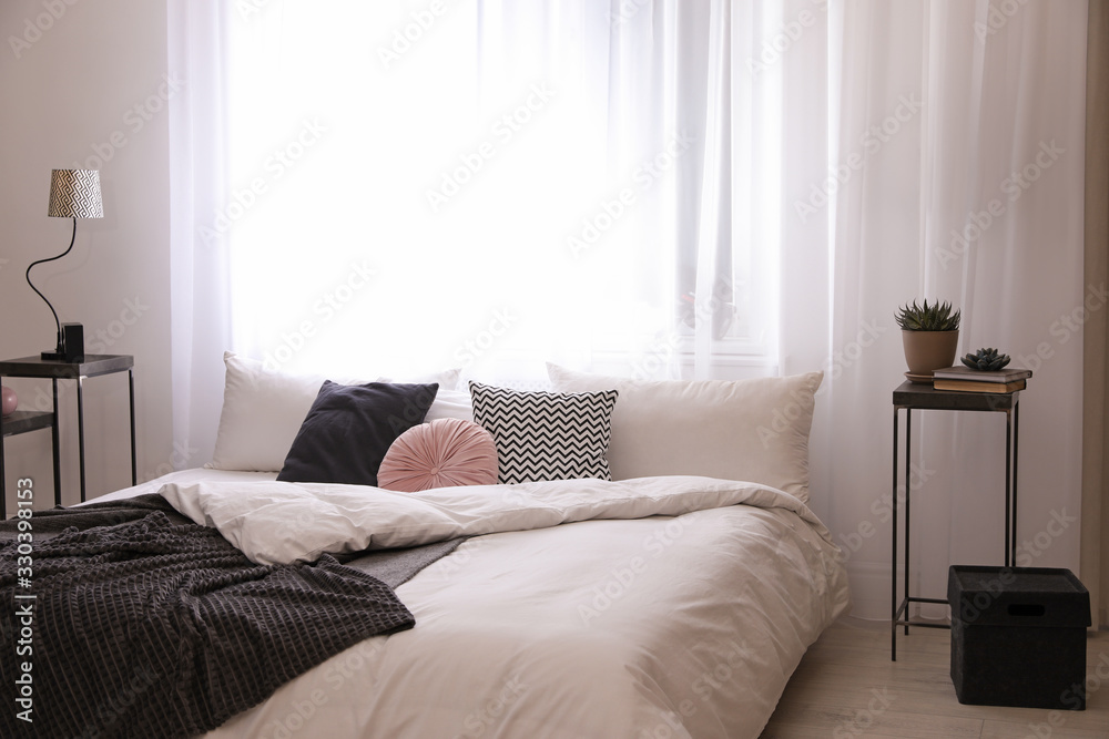 Large comfortable bed in stylish room interior Large comfortable bed in stylish room interior