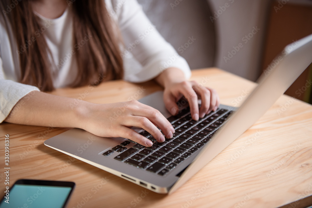 Close up of a woman hands typing on the laptop Close up of a woman hands typing on the laptop