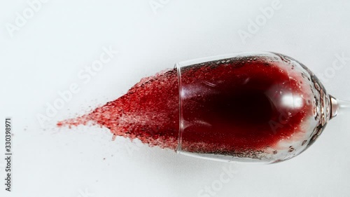 Super Slow Motion Top Shot of Falling Glass with Red Wine on White Cloth at 1000fps.