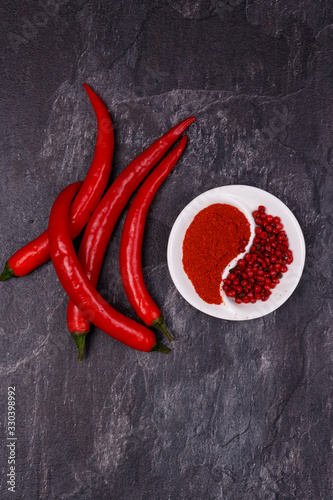Red pods of chili pepper, a plate with paprika