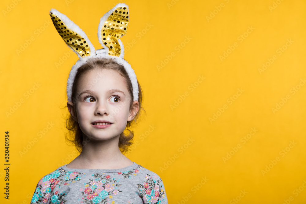 Cute little girl with bunny ears and basket full of Easter eggs - obrazy, fototapety, plakaty 