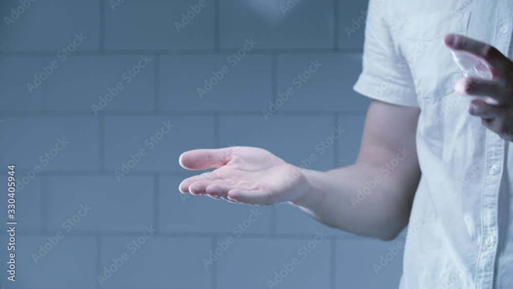 Man using hand sanitizer alcohol spray rub for hands hygiene in hospital for preventive coronavirus spread epidemic prevention.