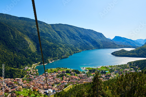 Aerial view over the beautiful Molveno town and Molveno lake, an alpine lake in Trentino, Italy