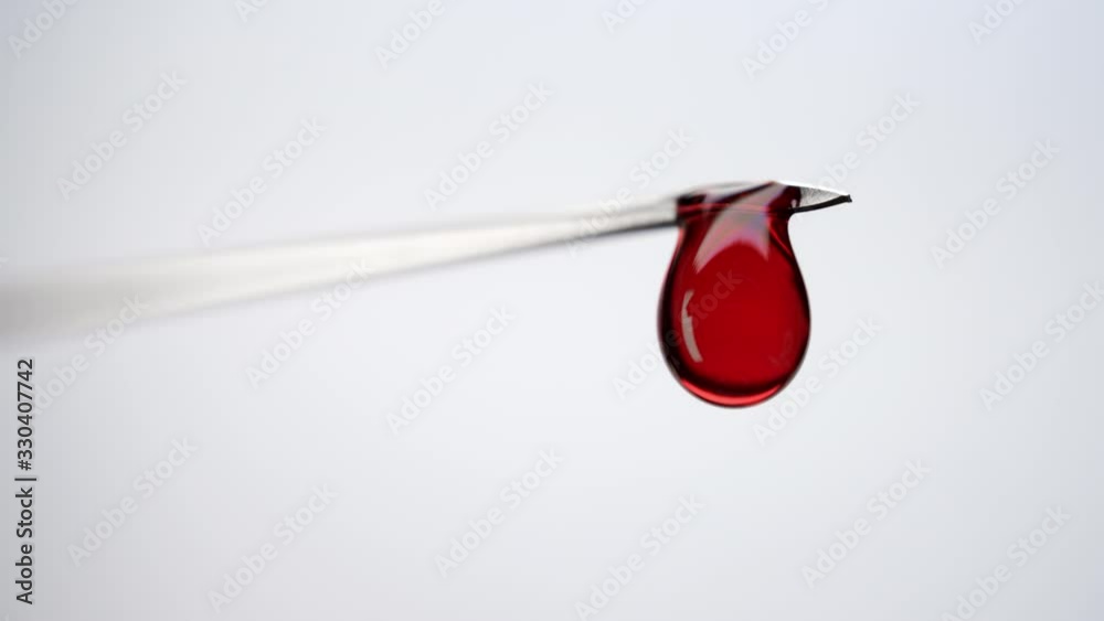 Blood drops leaking from syringe needle. Close-up red liquid dripping from syringe on white background Blood drops leaking from syringe needle. Close-up red liquid dripping from syringe on white background