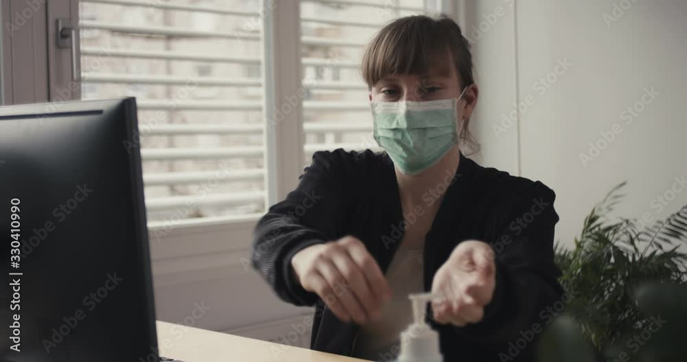 Woman put on face mask disinfectant work from home remotely office coronavirus social distancing containment self isolate quarantine