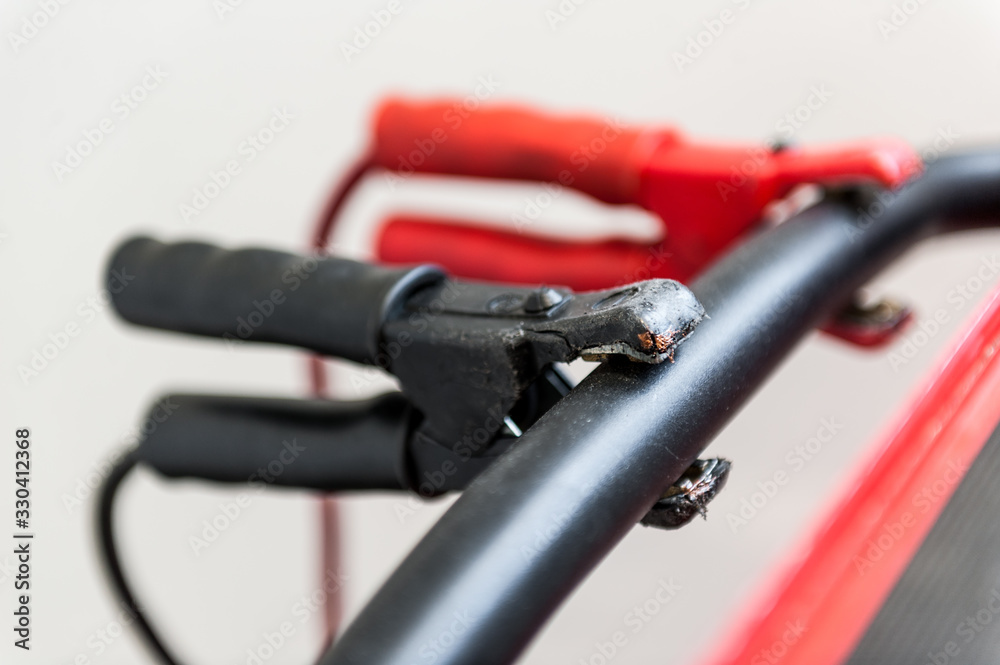 Black and red clamps for recharging car battery or welding work Black and red clamps for recharging car battery or welding work