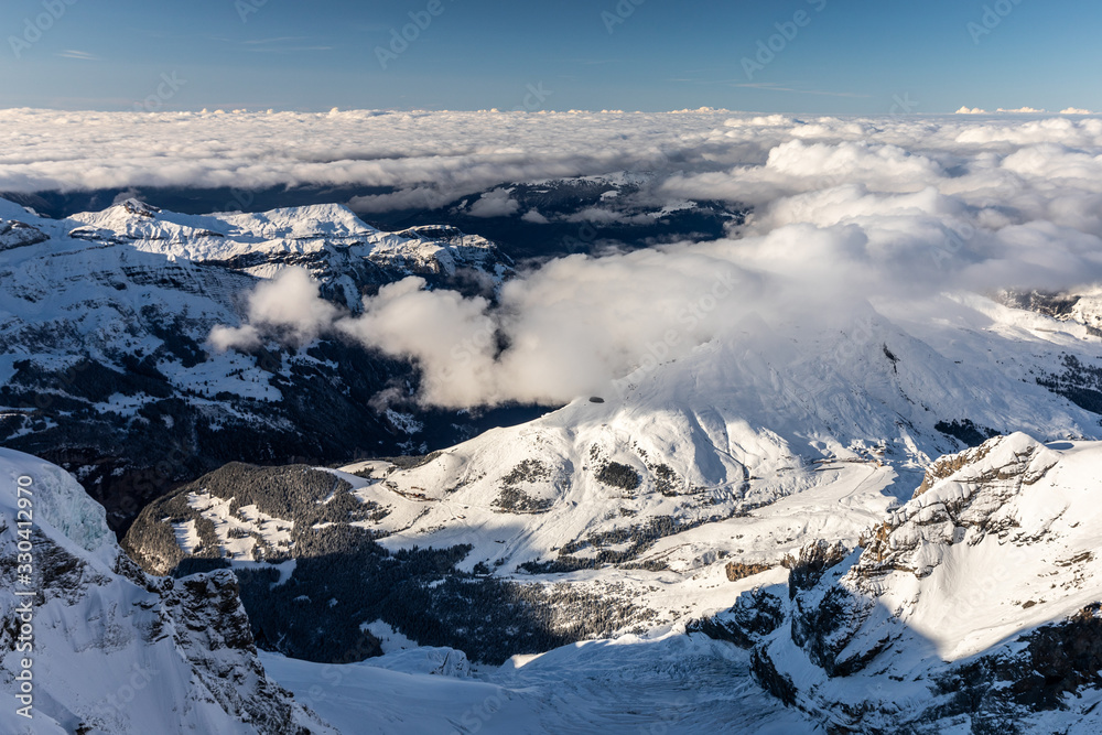 Fototapeta premium Aerial of snowcapped mountain range of Jungfrau in winter