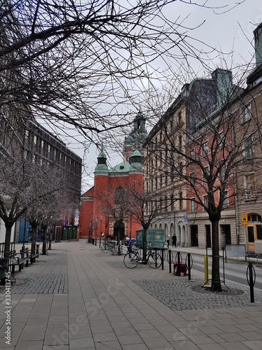 Stockholm  Sweden - March 16  2019  Street with a view of the Church of St. James. Church in the Royal Garden in Stockholm. Red church building with green domes