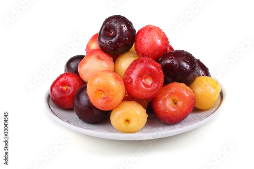 Different color cherries on dish