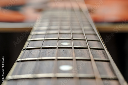 Neck with strings, close-up, on an old, classic acoustic guitar.