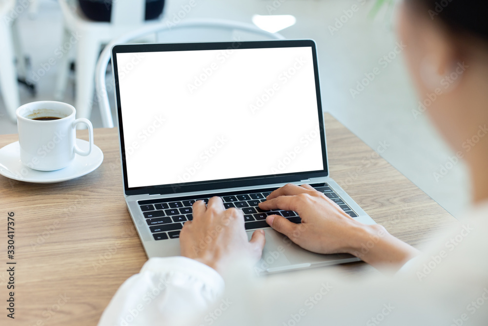 mockup image blank screen computer with white background for advertising text,hand woman using laptop contact business search information on desk at coffee shop.marketing and creative design mockup image blank screen computer with white background for advertising text,hand woman using laptop contact business search information on desk at coffee shop.marketing and creative design