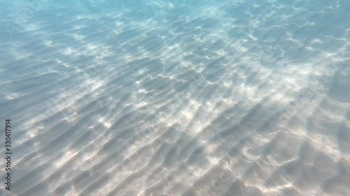 Clear water. underwater background with sandy sea bottom. Natural texture