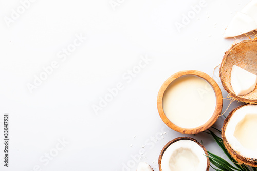 Coconut and bowl of coconut milk on gray background. Healthy food and drink