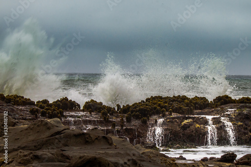 Waves crashing over rocks on the California coast.