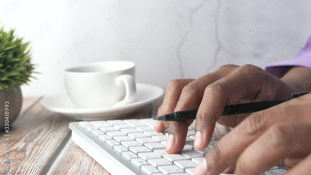 Close up of man hand typing on keyboard on table Close up of man hand typing on keyboard on table
