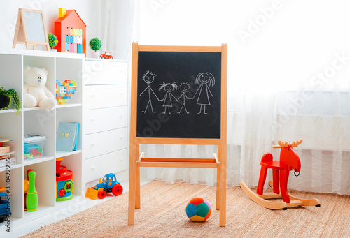 Children's playroom with plastic colorful educational blocks toys. Games floor for preschoolers kindergarten. interior children's room. Free space. background mock up chalkboard