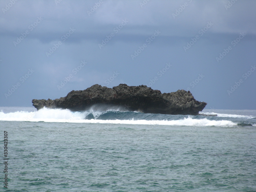 Crashing seas against a rock island