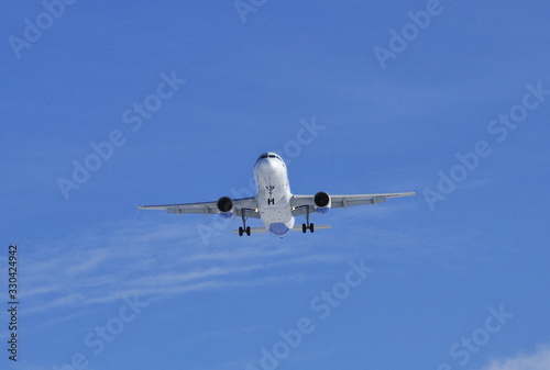 Landing the plane on a background of blue sky