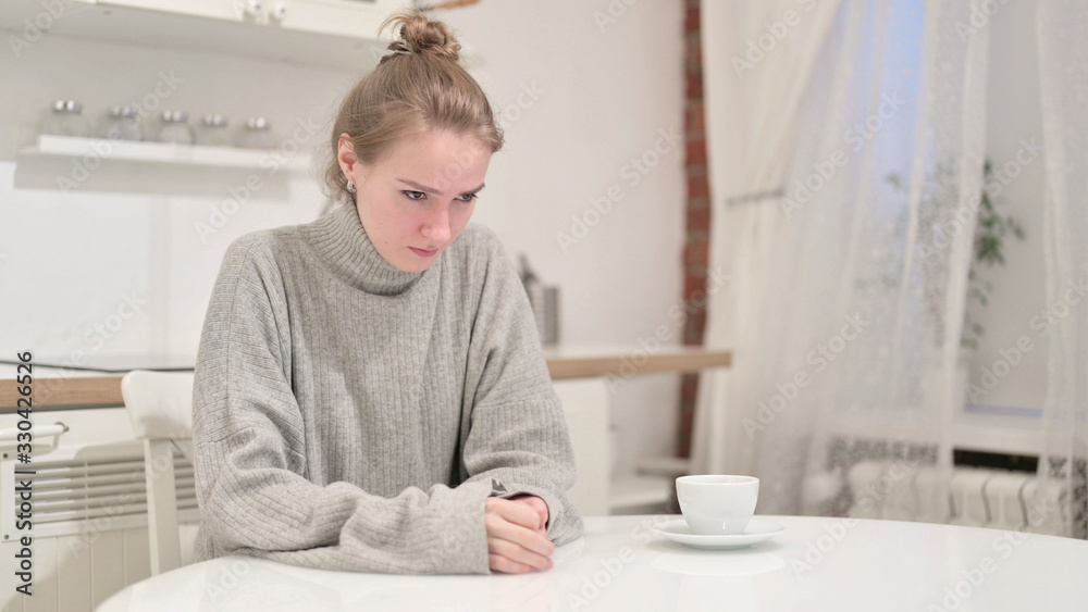 Unhappy Young Woman Thinking and Crying at Home