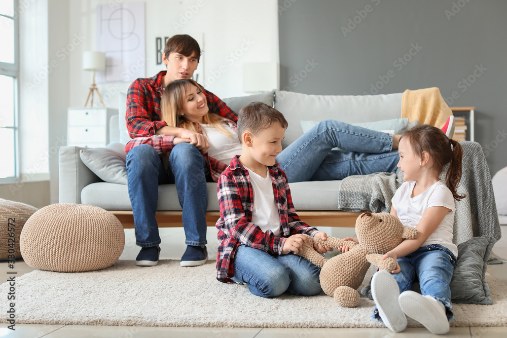 Portrait of happy family resting together at home