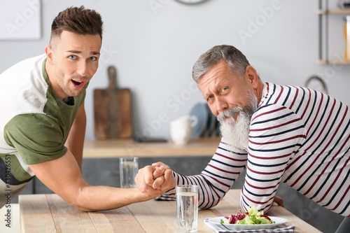 Senior man and his adult so...