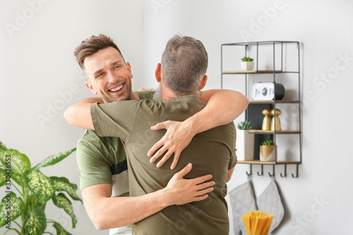 Senior man and his adult so...