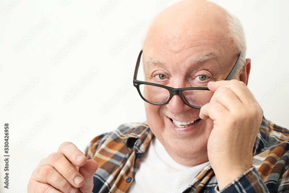 Portrait of elderly man on light background Portrait of elderly man on light background
