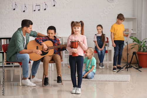 Teacher giving music lesson...
