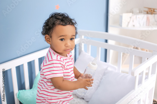Adorable baby standing in c...